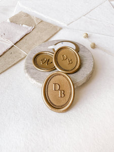 Gold colored monogram wax seals with personalized initials