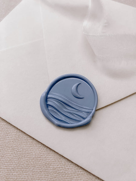 3D moon and ocean wax seal in dusty blue_side angle