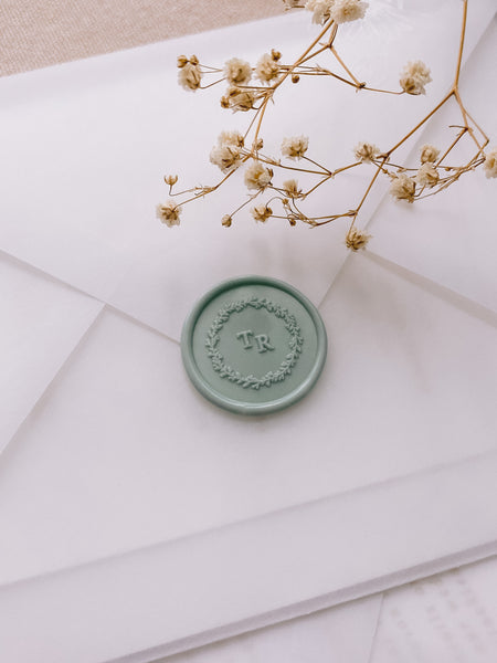 Leaf wreath monogram wax seal in sage green on vellum envelope
