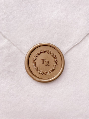 Leaf wreath monogram wax seal in gold on handmade paper envelope