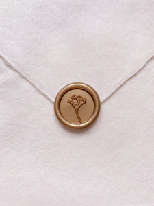 Flower design mini wax seal in gold on handmade paper envelope