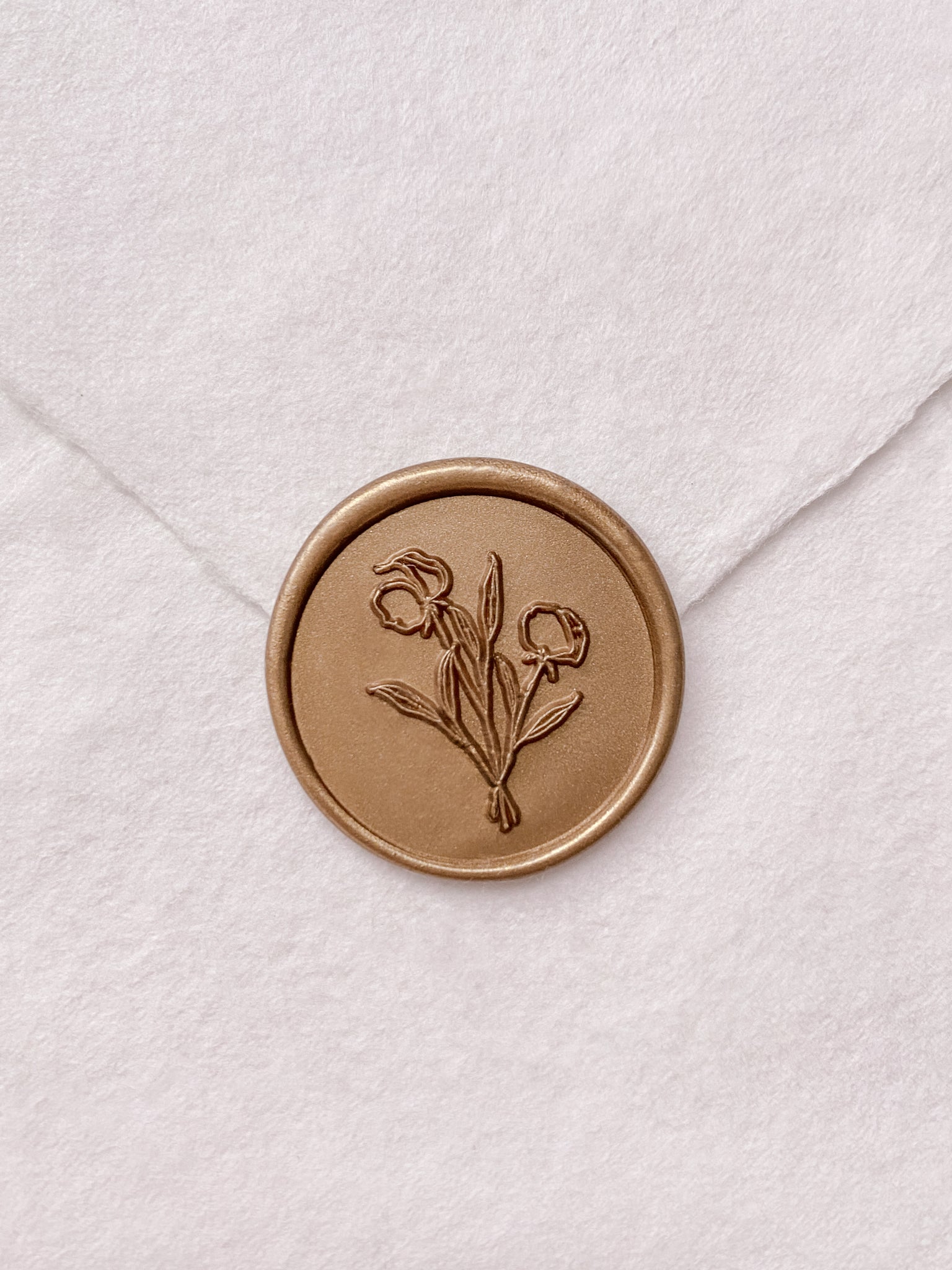 Flower bouquet wax seal in gold on handmade paper envelope