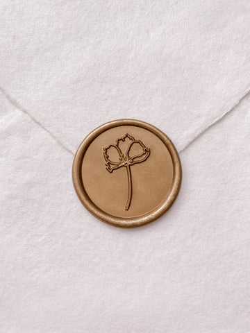 Simple flower round wax seal in gold on handmade paper envelope