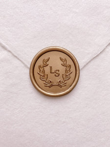 Leaf wreath monogram wax seal in gold on handmade paper envelope_front angle