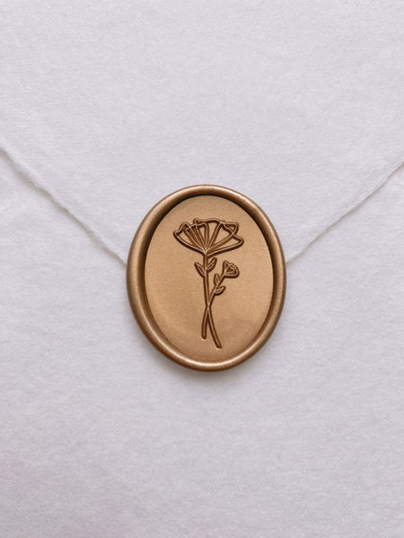 Abstract flower oval wax seal in gold on handmade paper envelope