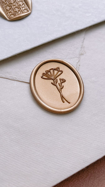 Abstract floral design oval wax seal in gold_side angle