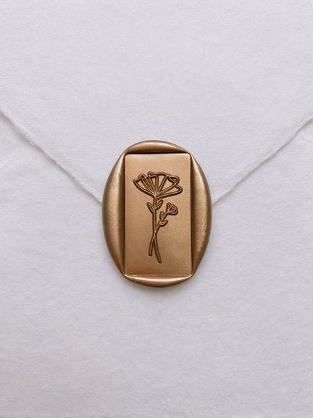 Abstract flower rectangular wax seal in gold on handmade paper envelope