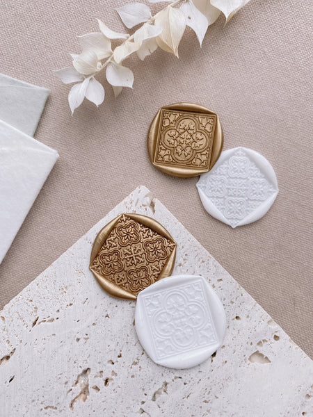 Moroccan tile pattern wax seals in gold and white