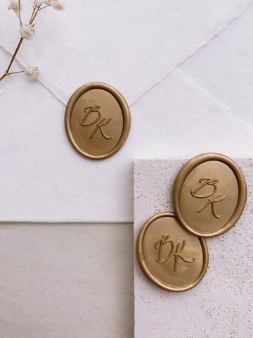 Calligraphy script monogram oval wax seals in gold