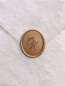 Calligraphy script monogram oval wax seal in gold_front angle