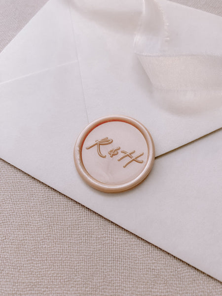 Calligraphy script monogram round wax seal in nude pearl
