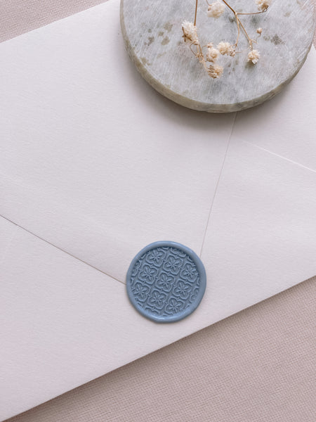 Moroccan tile pattern wax seal in dusty blue on paper envelope