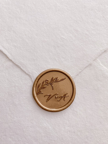 Floral branch round wax seal in gold with personalized calligraphy script monogram on handmade paper envelope