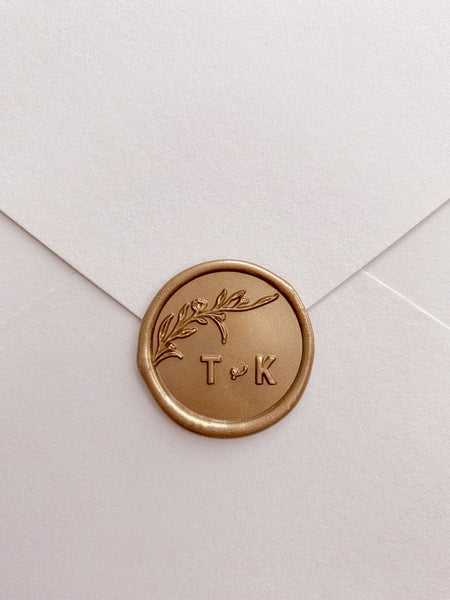 Floral branch monogram wax seal in gold with typeface initials