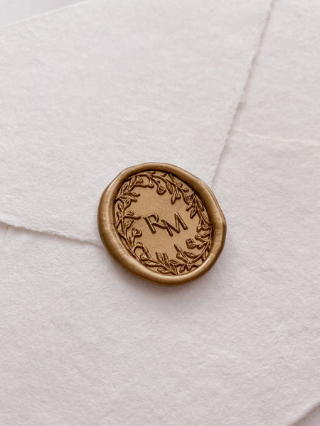 Oval floral crown monogram wax seal in gold_side angle