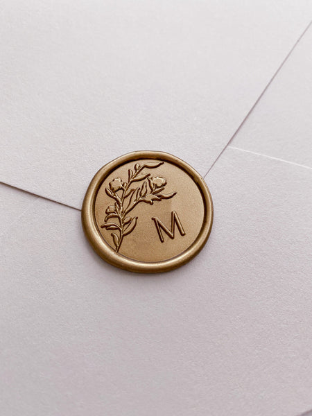 Floral silhouette single initial wax seal in gold on paper envelope_side angle