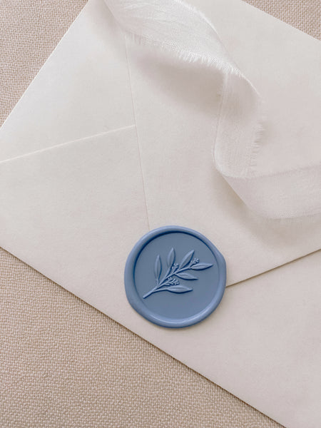 leaf branch wax seal in dusty blue_closeup side angle