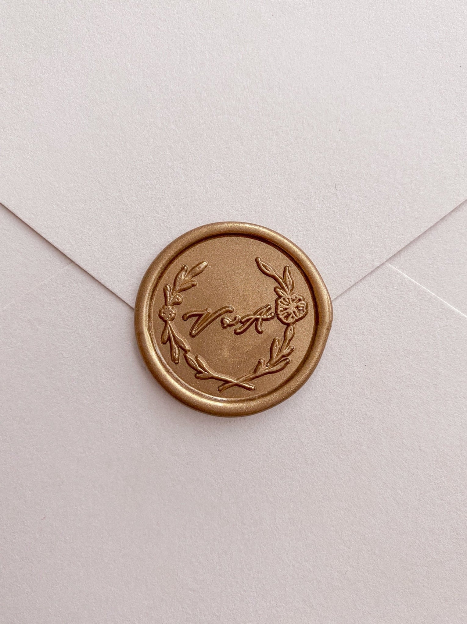 Floral leaf wreath monogram gold wax seal on beige card stock envelope 
