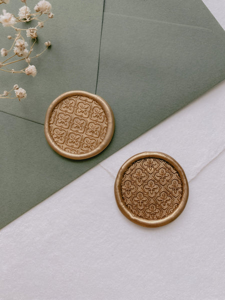 Moroccan tile pattern round wax seals in gold_front angle on olive green and white envelopes