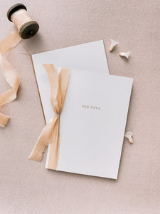 Gold foil beige card stock vow books, set of 2 tied in silk ribbon and fine twine