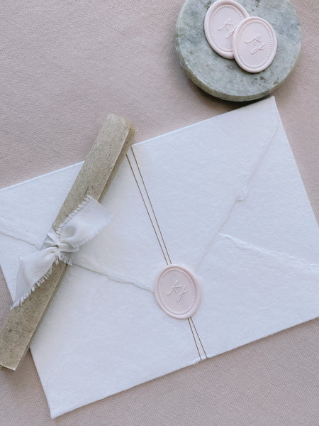ivory nude colored oval monogram wax seal on handmade paper envelope_side angle