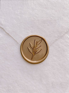 Leaf branch wax seal in gold on handmade paper envelope_front angle