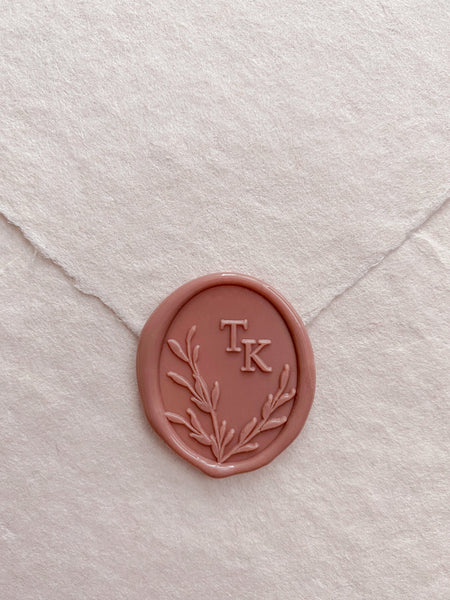 Oval leaves wreath monogram wax seal in dusty rose on handmade paper envelope