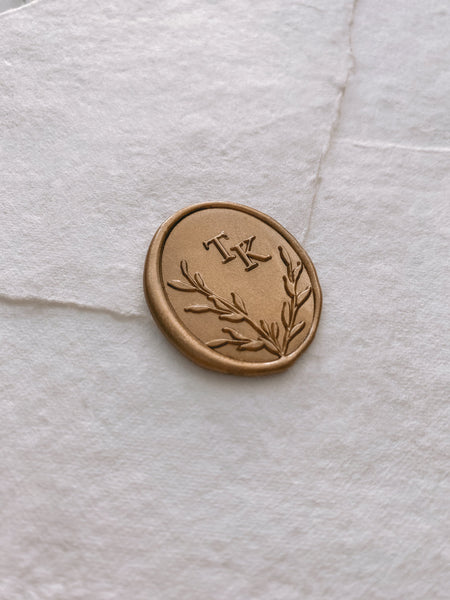 Oval leaf wreath monogram wax seal in gold on handmade paper envelope_side angle