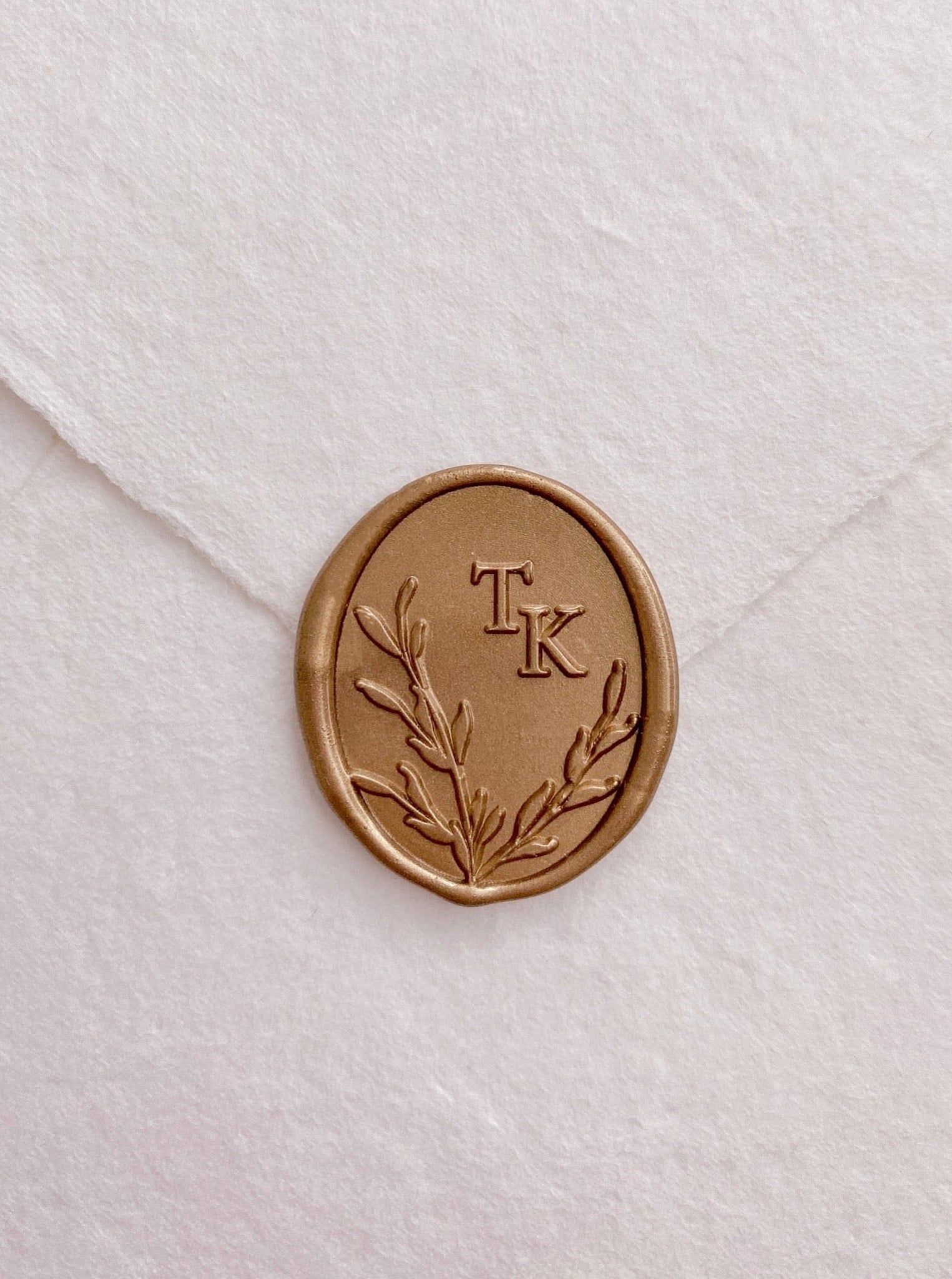 Oval leaves wreath monogram wax seal in gold on handmade paper envelope