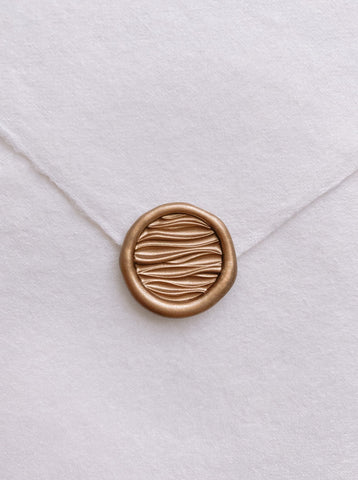 Mini 3D ocean waves wax seal in gold on handmade paper envelop_front angle