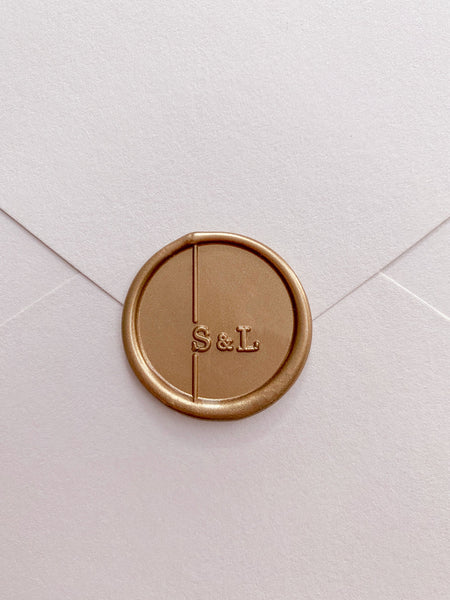 Modern monogram round wax seal in gold_front angle