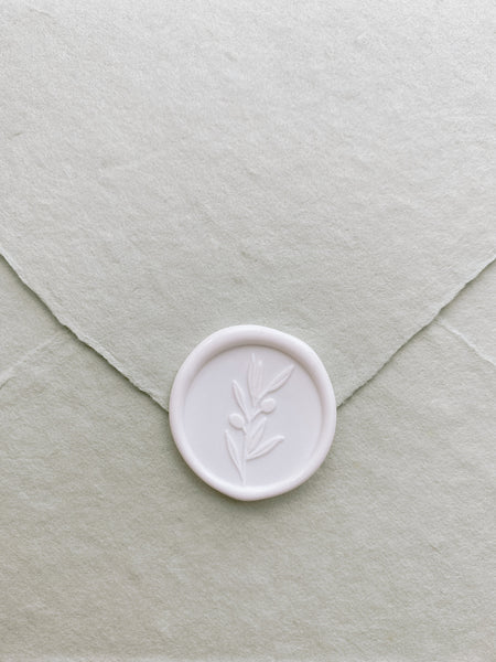 Olive branch wax seal sticker in white on handmade paper envelope