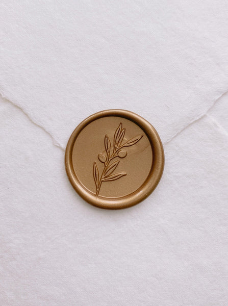 Olive branch gold wax seal on handmade paper envelope