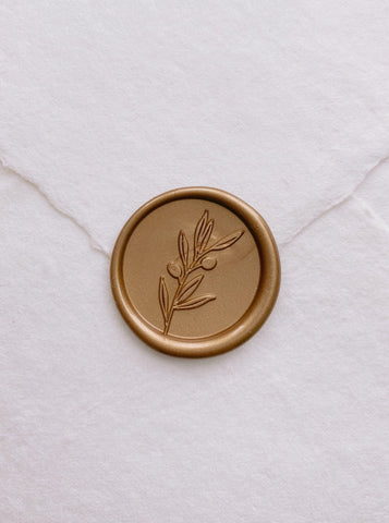 Olive branch gold wax seal on handmade paper envelope