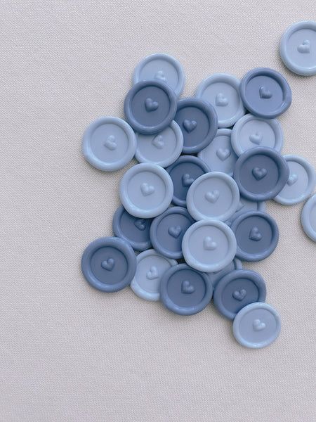 Pale blue and dusty blue colored mini heart wax seals