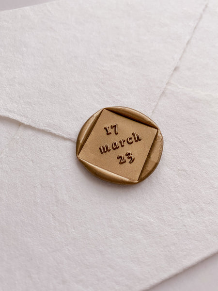 Personalized wedding date diamond shaped wax seal in gold_side angle