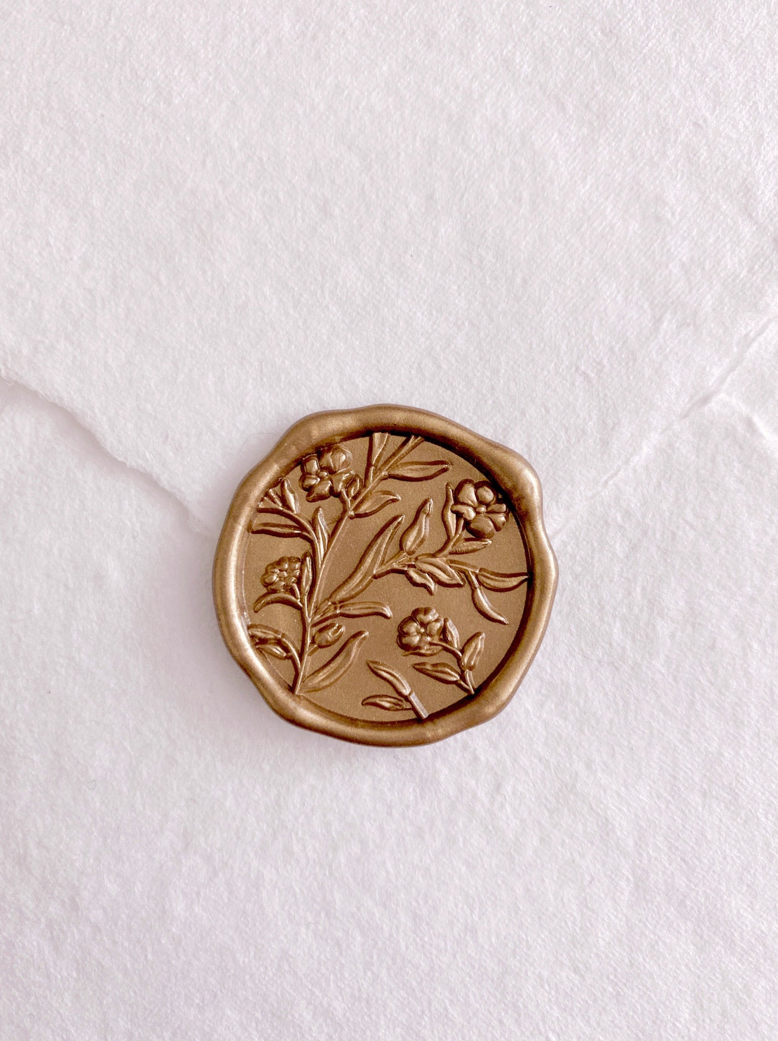 3D floral gold wax seal on handmade paper envelope_closeup front angle