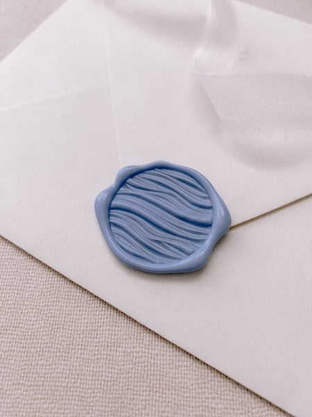 3d waves wax seal in dusty blue color on paper envelope