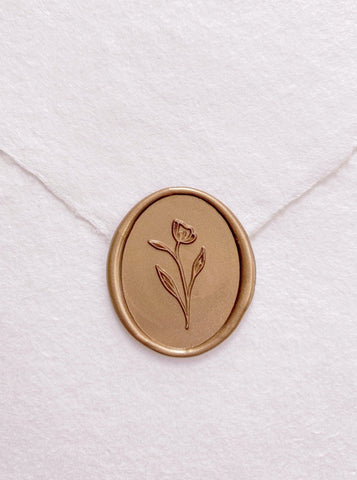 Simple flower oval wax seal in gold on handmade paper envelope