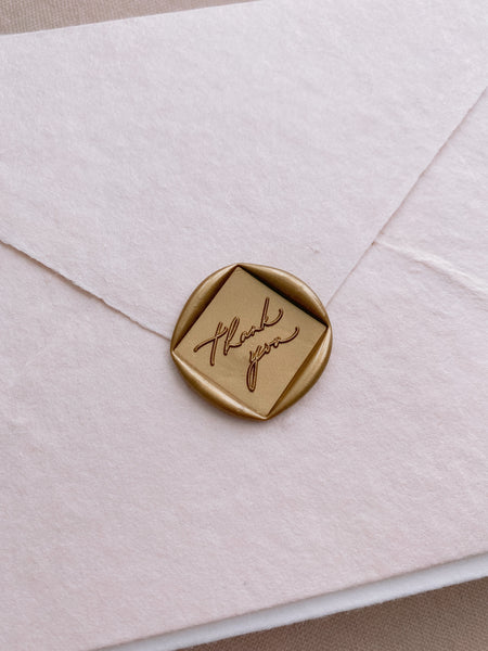 Thank You calligraphy script diamond shaped wax seal in gold on handmade paper envelope