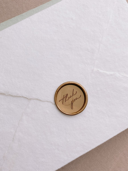 Thank You calligraphy script round wax seal in gold on handmade paper envelope_side angle