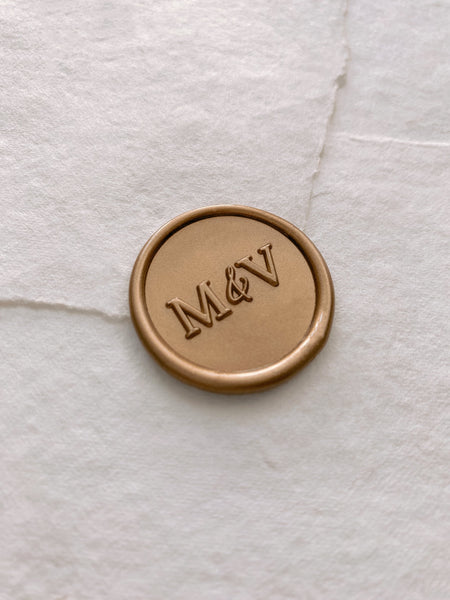 Monogram round wax seal in gold on handmade paper envelope_side angle
