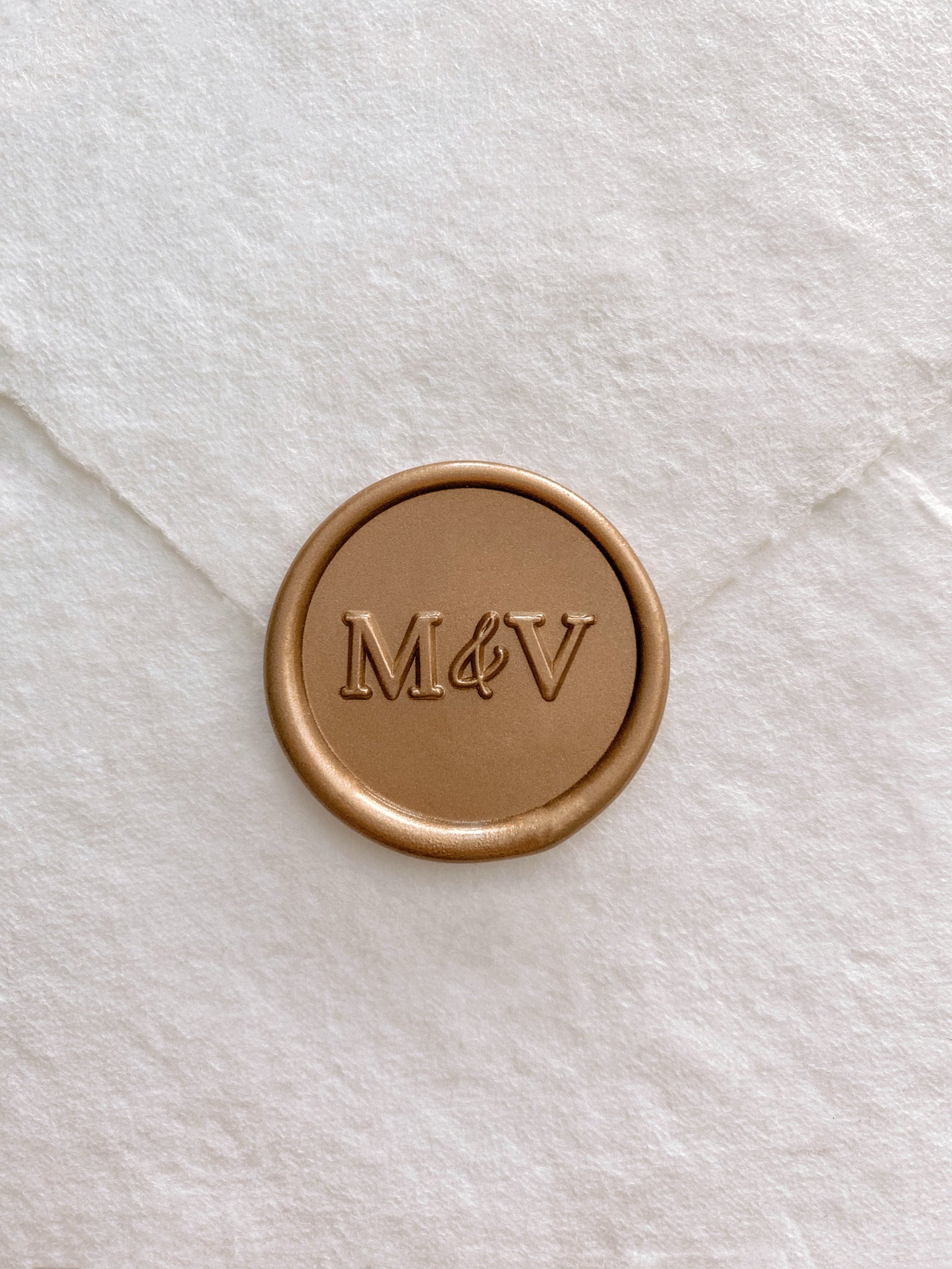 Typeface monogram round wax seal in gold