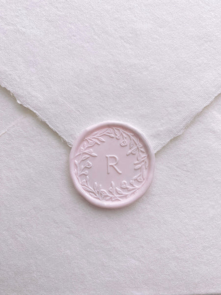Floral crown single initial wax seal in light blush color on handmade paper envelope
