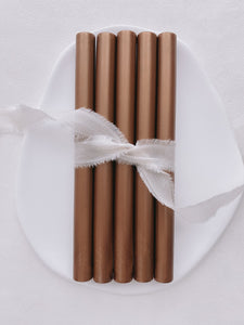 a set of 5 copper sealing wax sticks