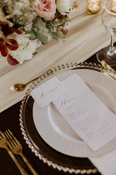 handmade paper place card and menu in white color hand lettered in modern calligraphy in brown ink in table setting