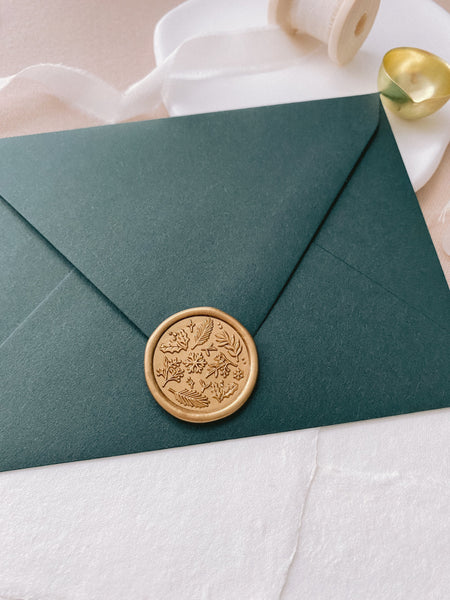 Winter Garden wax seal in gold on dark green envelope